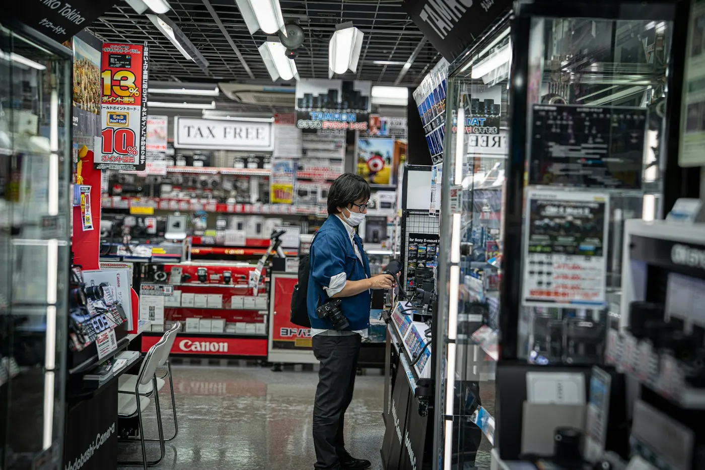 Shopper browsing a brightly lit electronics store