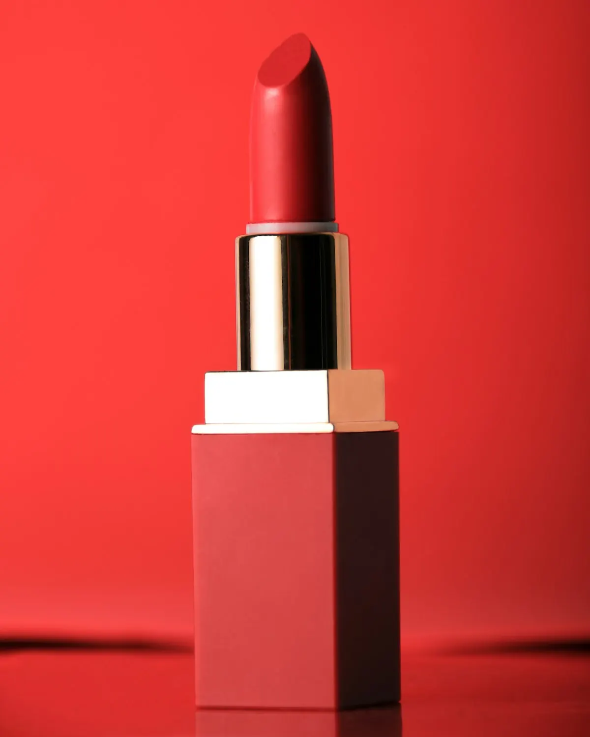 Red lipstick standing on a red background