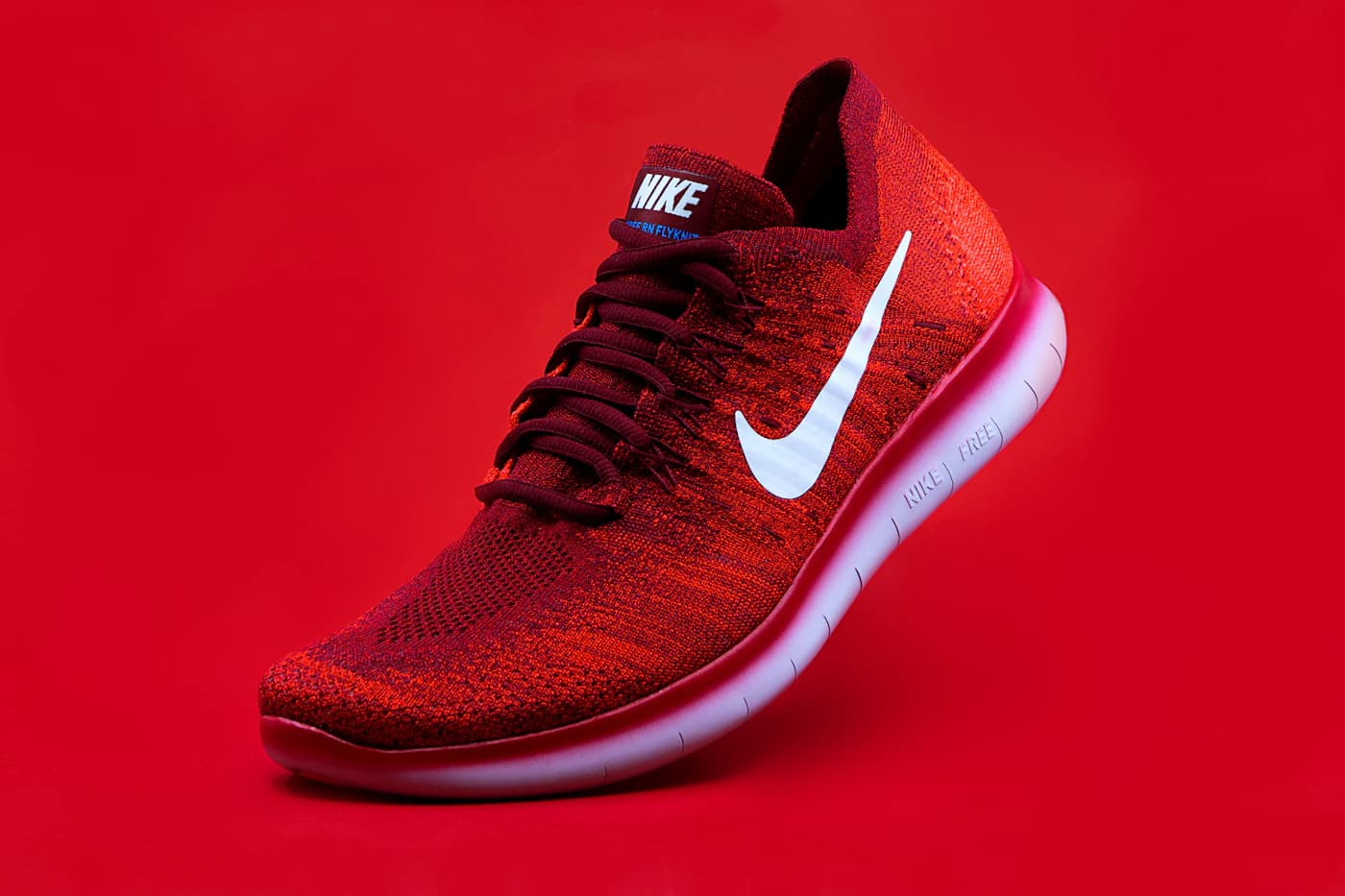 Red running shoe on a red background